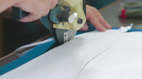 Tailor cutting the patterns with electric saw Stock Footage 62355704