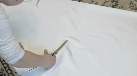 Tailor cutting white silk fabric for gown Stock Footage 61257013