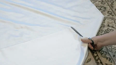 Tailor cutting white silk fabric for gown Stock Footage 61257120