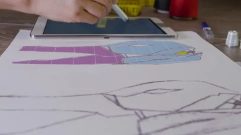 Tailor Designer Sketching On A Tablet Stock Footage 243613328