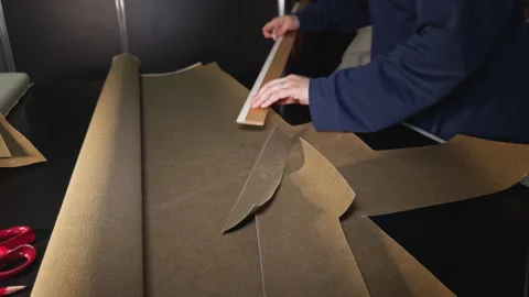 The Tailor is Drawing Measurements on the Fabric with Chalk and a Ruler Stock Footage 329146237