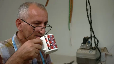 Tailor is drinking tea. Slow-motion Stock Footage 73359748