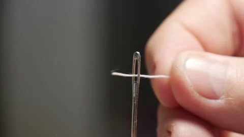 Tailor Hand Inserting Sewing Thread in Needle Hole. Man Preparing a Needle. Stock-Footage 220409318