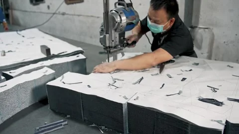 Tailor Hands Operating Electric Rotary Cutter Machine through Fabric Layers Stock Footage 337087246