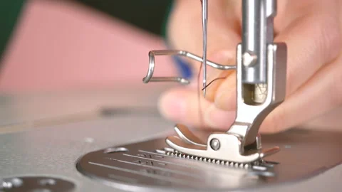 The tailor inserts the thread into the needle. Video stock 88785605
