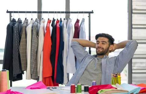 The tailor lay back and rest while thinking of a new shirt design Stock Photos