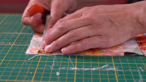The tailor makes markings on fabric. Stockbeeldmateriaal 90599075