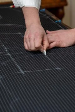 Tailor man is engaged in making clothes in a sewing workshop, close-up of han Stock Photos