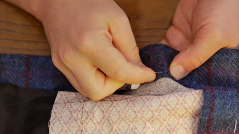 Tailor man working and hand sewing a tweed jacket in his tailor shop, Tailoring, Stock Footage 143297822