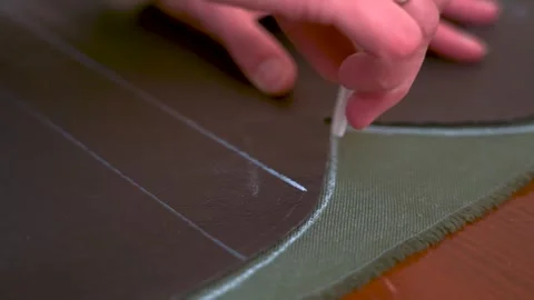 Tailor marking fabric with chalk before cutting Stock Footage 321287746