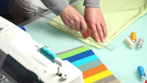 Tailor marking mint fabric with a tailor's chalk.  Real time video. Stock Footage 260828565