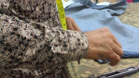 Tailor Measuring and Cutting Fabric with Scissors Close-up Stock Footage 327768639