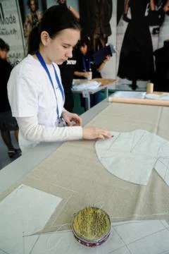 Tailor measuring necessary amount of material Stock Photos