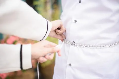Tailor measuring the size for a tailor Stock Photos