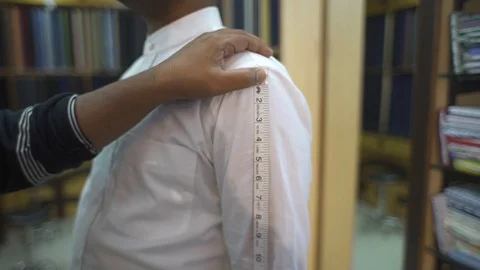 Tailor Measuring  Sleeve Length Of Man Shirt With Measuring Tape Close-Up Stock Footage 113199626