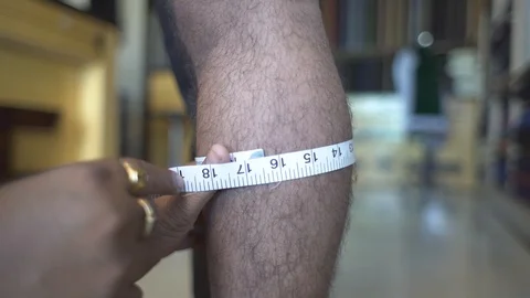 Tailor Measuring Width Of Man Calf For Trouser. Close Up. Stock Footage 113273491
