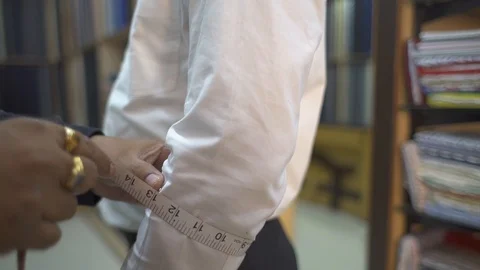 Tailor Measuring Width Of Man Elbow With Measuring Tape In A Shop. Close-Up Stock Footage 113274258