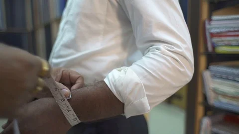 Tailor Measuring Width Of Man Wrist With Measuring Tape In A Shop. Close-Up Stock Footage 113274223