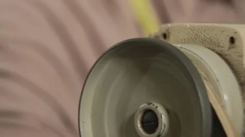 Tailor moving the wheel of sewing machine to start it's functioning. Video stock 149452980