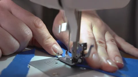 Tailor repairs or makes new clothes using professional sewing machine, close up Video stock 150313938
