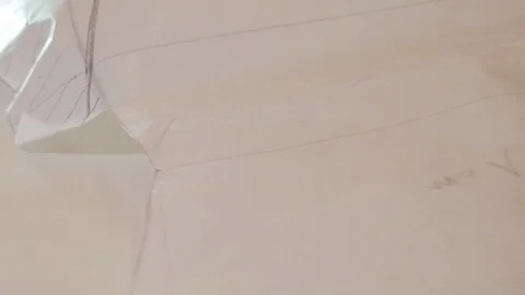 Tailor reviewing patterns and hand drawings. In sewing and fashion design, a Stock Footage 126501423