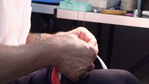 The tailor rips clothes with his hands Stock Footage 94163462