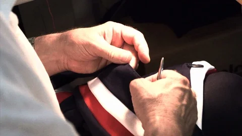 The tailor rips clothes with his hands Stock Footage 94165970