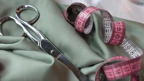 Tailor scissors and meter on pastel fabric. Stock Footage 174675516