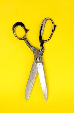 Tailor scissors on yellow background Stock Photos