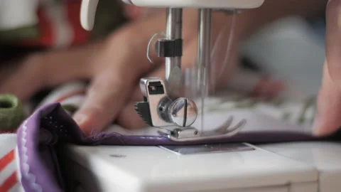 Tailor sew on sewing machine, close up with selective focus Stock Footage 156384508