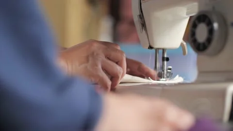 Tailor sew on sewing machine, close up with selective focus Stock Footage 156384542
