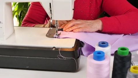 Tailor Sewing Clothes with her Sewing Machine Video stock 80558001