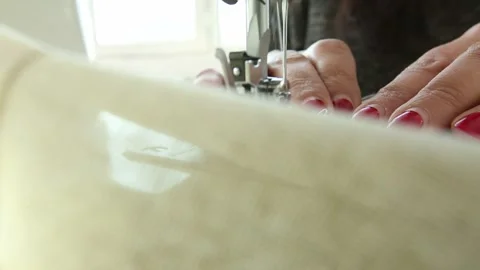 The tailor is sewing clothes with a sewing machine 6 Stock Footage 311645748