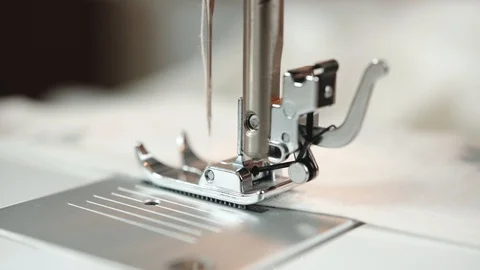 Tailor sewing clothes. Women's hands behind her sewing. Stockbeeldmateriaal 110893196