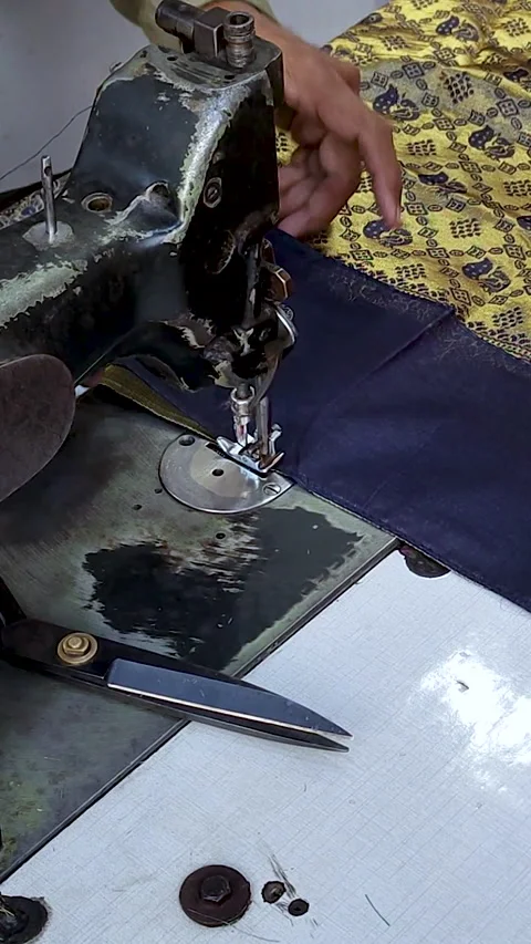 Tailor sewing fabric on industrial machine close up hands working Stock Footage 328664660