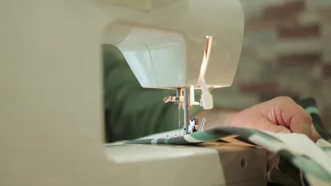 Tailor sewing fabric with sewing machine 動画素材 309599937