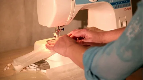 Tailor at the Sewing Machine Sews Medical Face Mask to Protect of COVID-19 Stock Footage 129057177