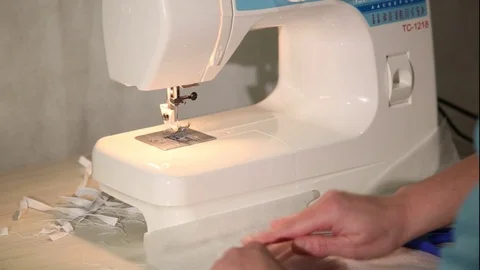 Tailor at the Sewing Machine Sews Medical Face Mask to Protect of COVID-19 Stock Footage 129057328