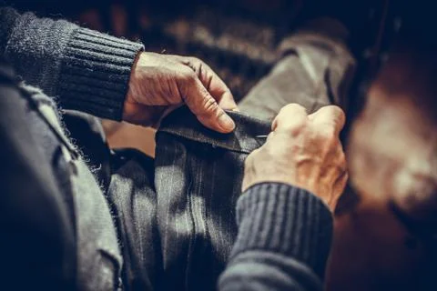 Tailor sewing some fabric Stock Photos