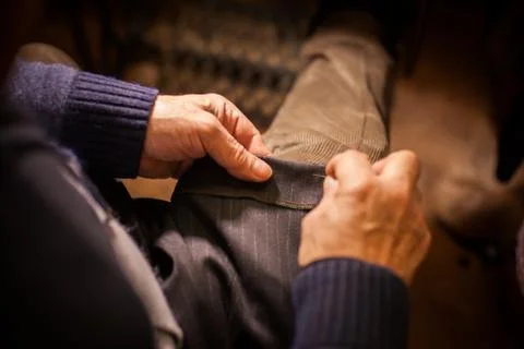 Tailor sewing some fabric Stock Photos