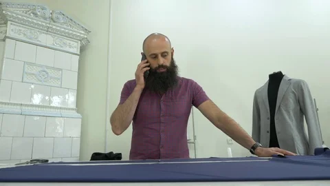 A tailor in a sewing workshop at work. Stock Footage