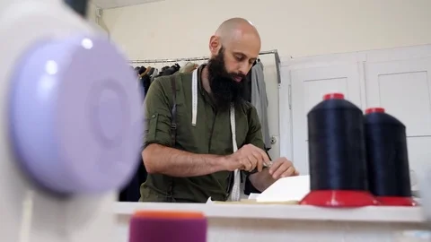 A tailor in a sewing workshop at work. Video stock 80738326