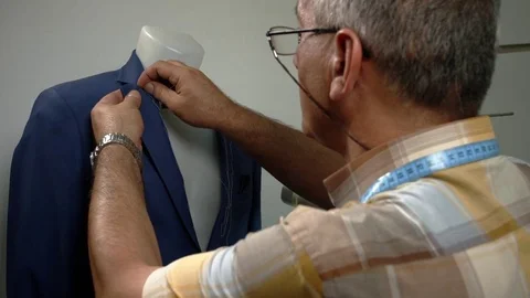 Tailor sews clothes with a needle on a dummy. Slow-motion 動画素材 73360134