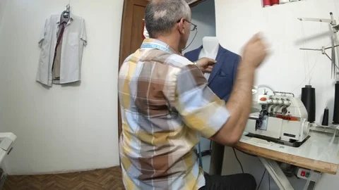 Tailor sews clothes with a needle on a dummy in workshop 動画素材 73363417