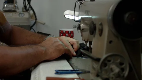 Tailor sews clothes on a sewing machine. Slow-motion Video stock 73359968