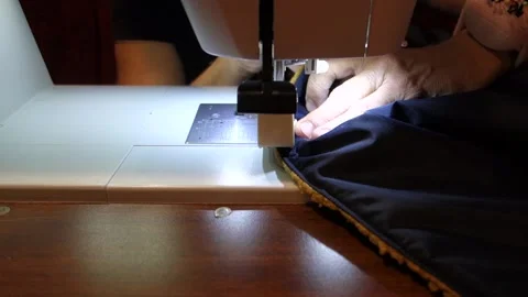The tailor sews a fur blanket on a sewing machine for cold and winter weather Stock Footage 166527872
