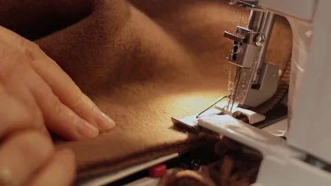 Tailor sews on an overlock ( sewing machine). Woman hands with fabric. Stock Footage 150160485