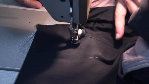 The tailor sews on the sewing machine Stock Footage 94399173