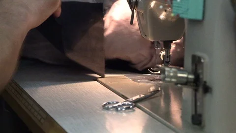 The tailor sews on the sewing machine Stock Footage 94403934
