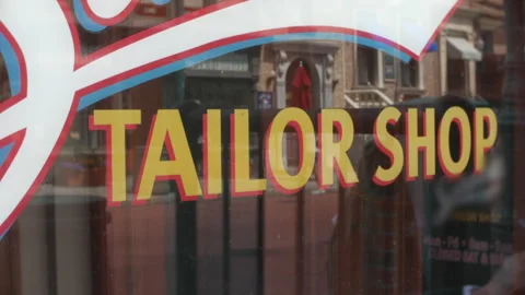 Tailor Shop Lettering on Storefront Window Bold Yellow Typography Urban Retail Stock Footage 334699376